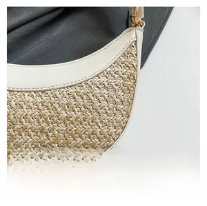 Close-up of woven chevron texture and leather trim on the summer crescent shoulder bag