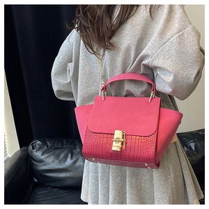 Detail of pink crossbody bag with matte suede splicing and crocodile pattern leather