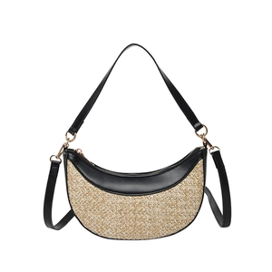 Minimalist straw and black leather crescent bag with dual straps on white background