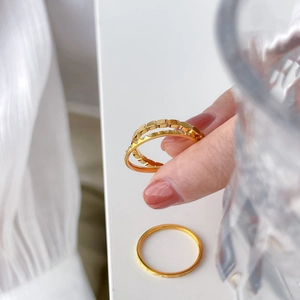 Tre delicati anelli in titanio placcato oro 18K con motivi geometrici a rombi