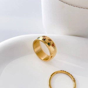 Detail of gold-plated wide band ring with colorful star and moon pavé crystals