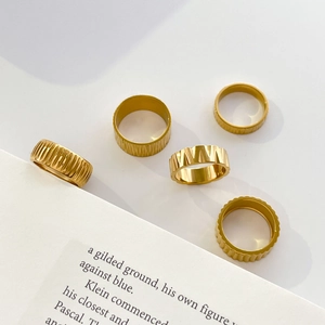5-piece gold titanium steel ring set with geometric bark texture and gear designs