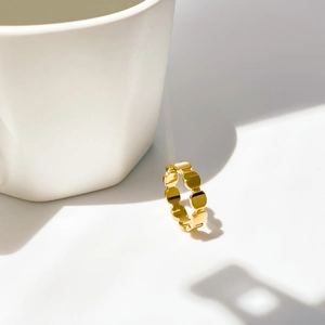 Macro view of 18K gold plated fish scale gear ring with minimalist geometric design