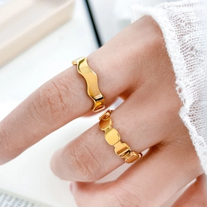 Minimalist 18K gold plated titanium ring set with wavy design and geometric patterns