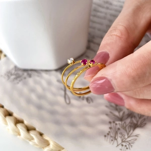 Three-piece stackable gold rings featuring colorful zircon stones and geometric patterns