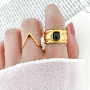 Gold wide band ring set with black zircon stones and V-shaped minimalist ring