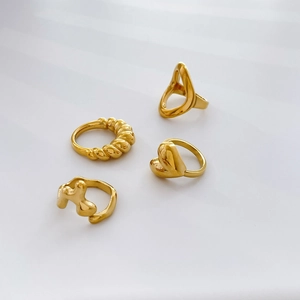 Set of four unique gold-plated stainless steel rings with fluid lava and heart designs