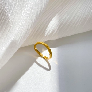 Macro shot of 18k gold plated titanium steel ring with geometric faceted texture