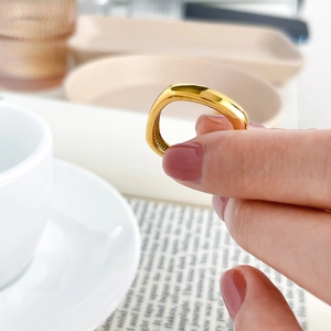 Detail shot of a square rounded 18k gold plated ring with a mirror-polished finish