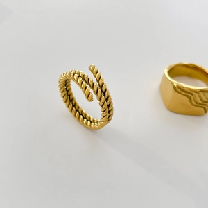 Detailed view of 18K gold plated stackable rings with twisted rope and wavy fluid texture