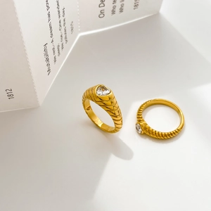Macro shot of 18K gold plated heart ring and textured band with sparkling zircons