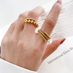 Detail of twisted rope texture and gradient bead rings in gold-plated stainless steel