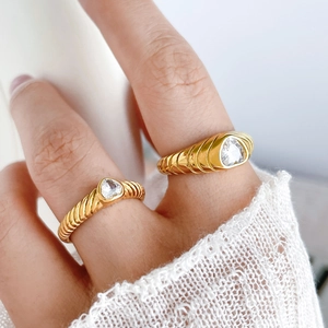 Detailed macro view of 18K gold plated croissant rings with triangle cut zircon stones