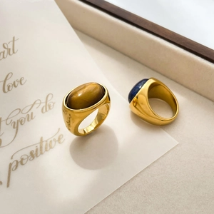 Macro detail of vintage 18K gold plated rings with tiger eye and lapis lazuli stones