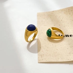 Detail of vintage 18K gold plated rings featuring oval lapis and malachite stones