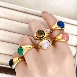Close-up of vintage 18K gold plated rings with colorful oval cabochon gemstones