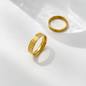 Close-up of golden vintage rings with Chinese characters and gear pattern texture