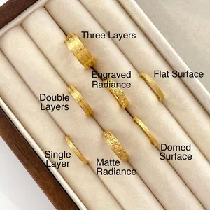 Detail view of 18K gold plated titanium rings with star engraving and sandblasted finish