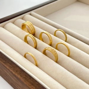 Set of 7 gold-plated titanium steel rings featuring matte, frosted and star-engraved textures