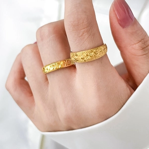 Macro shot of 18K gold plated frosted rings with engraved star patterns on stackable bands