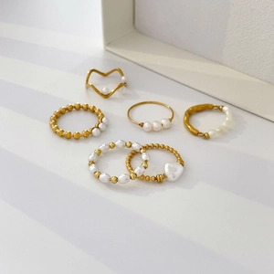 Elegant 18K gold plated stackable ring set featuring freshwater pearls and beads on white