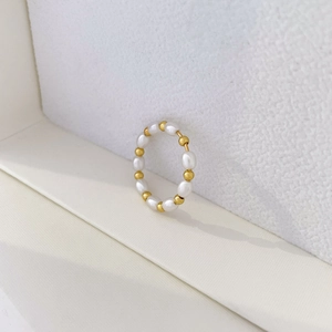 Detail of freshwater pearl and 18K gold-plated beaded ring with natural luster on white