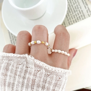 Freshwater pearl bead rings in 18K gold plated steel shown on model with coffee