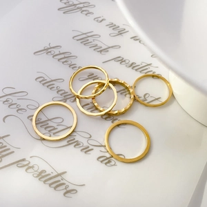 Set of six gold geometric faceted rings with textured hammer finish in a luxury display