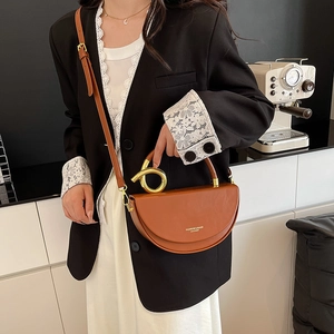 Brown semi-circular leather handbag with elegant gold metal handle and shoulder strap