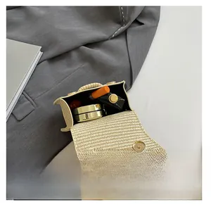 Internal storage view of mini woven bag with cosmetics showing compact capacity