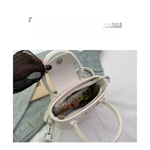 Internal view of white leather tote bag showing spacious compartments and storage