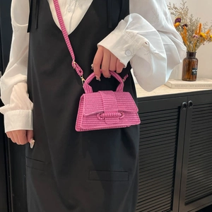 Peach pink mini woven top-handle bag with hourglass silhouette and crossbody strap