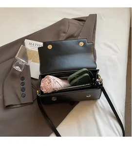 Interior view of black flap crossbody bag showing spacious capacity for phone and umbrella