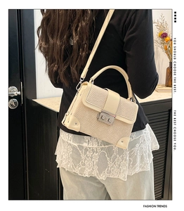 Back view of model wearing a woven texture box bag in cream with silver hardware details