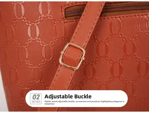 Close-up of orange leather bag featuring diamond embossing and gold metal strap buckle