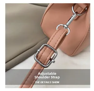 Macro detail of the adjustable pink leather shoulder strap with silver metal buckle
