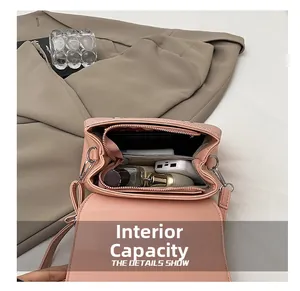 Top view of pink crossbody bag interior showing main compartment and storage capacity