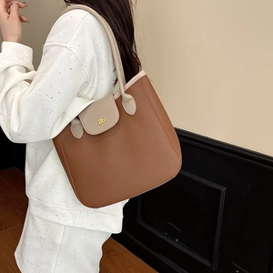 Minimalist brown and beige leather tote bag with gold logo and lychee pattern