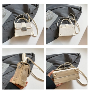 Detailed views of creamy white snakeskin embossed box bag with vintage metal clasp lock