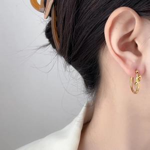 Elegant 18K gold plated C-shaped twist knot hoop earrings with textured crater design
