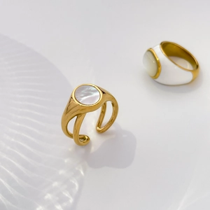 Detail of gold titanium rings with white mother of pearl inlay and artistic water shadows