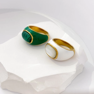 Detailed view of vintage gold rings with green malachite and white mother of pearl inlay