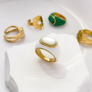 Macro shot of vintage gold rings with colorful enamel and shell inlay details