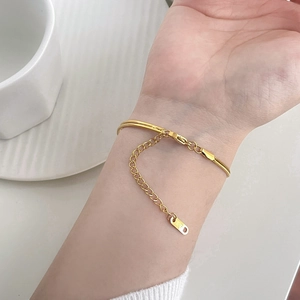 Detail of 18K gold plated bracelet showing lobster clasp and engraved K18 tag extension