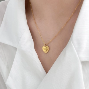 Collier avec pendentif cœur plaqué or 18 carats et gravure porté par un mannequin