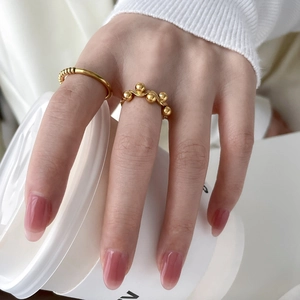 Polished 18K gold plated beaded wave ring with twisted texture for women worn on hand