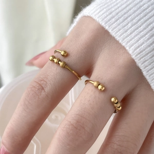 18K gold plated beaded wave ring with movable steel beads shown on fingers