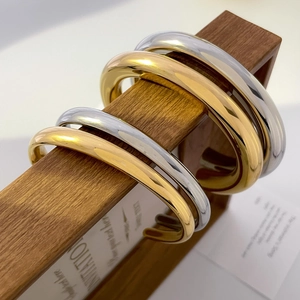 Detail of 18K gold and silver plated chunky hollow bamboo bead bangles on display