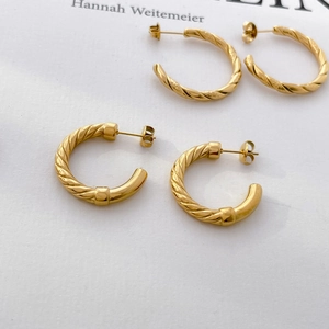 Detail shot of two pairs of 18K gold plated twisted rope C-shaped hoop earrings