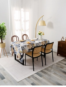 Detail of tropical printed tablecloth with toucans and leaves on a dining table